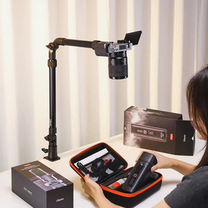 Ulanzi ZJ02 camera stand with camera and accessories, black metal desk mount.