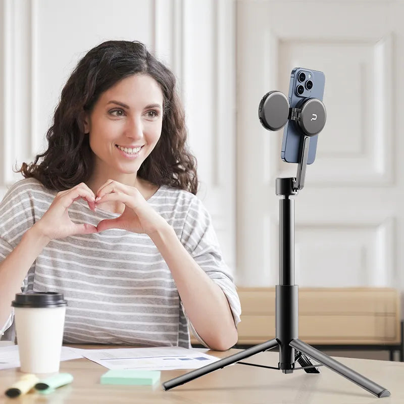 Woman using Ulanzi Magnetic Phone Selfie Stick Tripod for indoor selfies and vlogging.