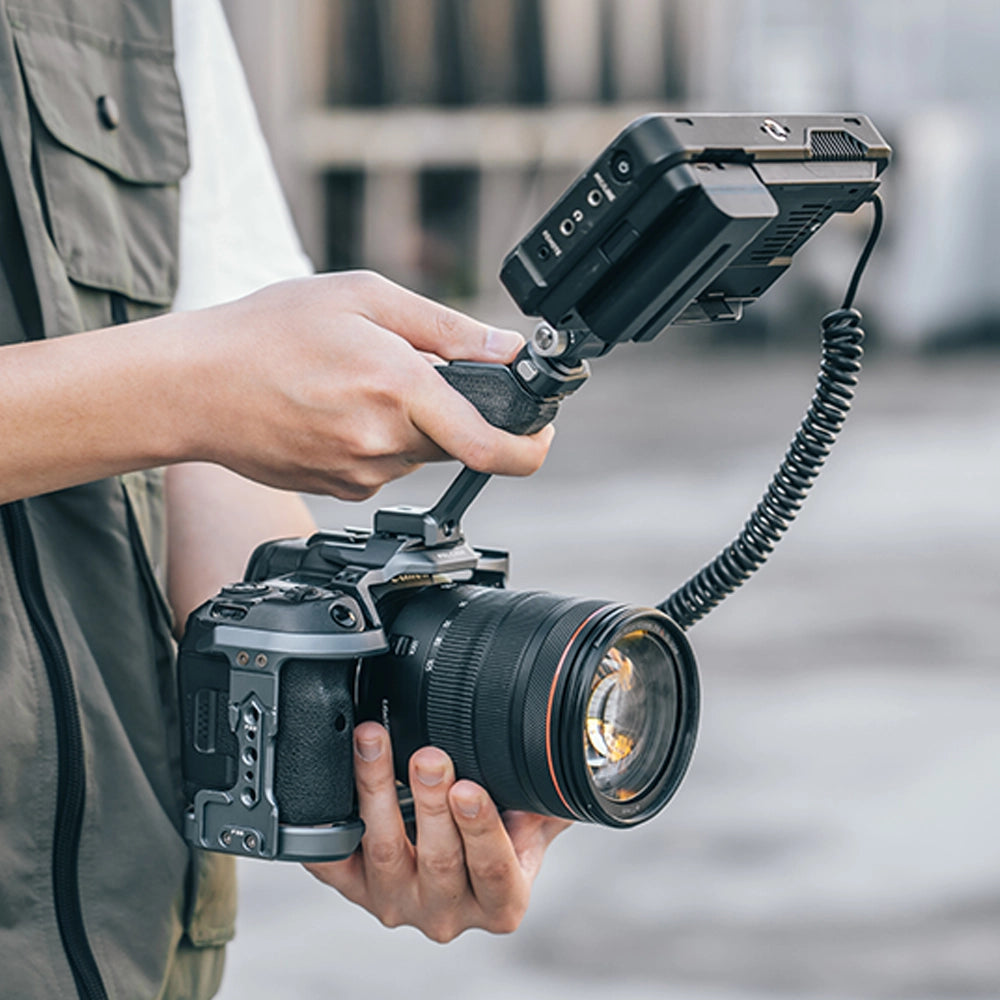 User holding Ulanzi Falcam F22 Quick Release Top Handle on a DSLR camera setup.