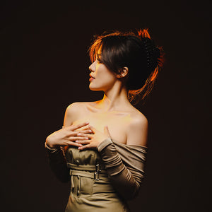 Woman in beige dress, photographed using Ulanzi LM07 flashlight, portrait photography.