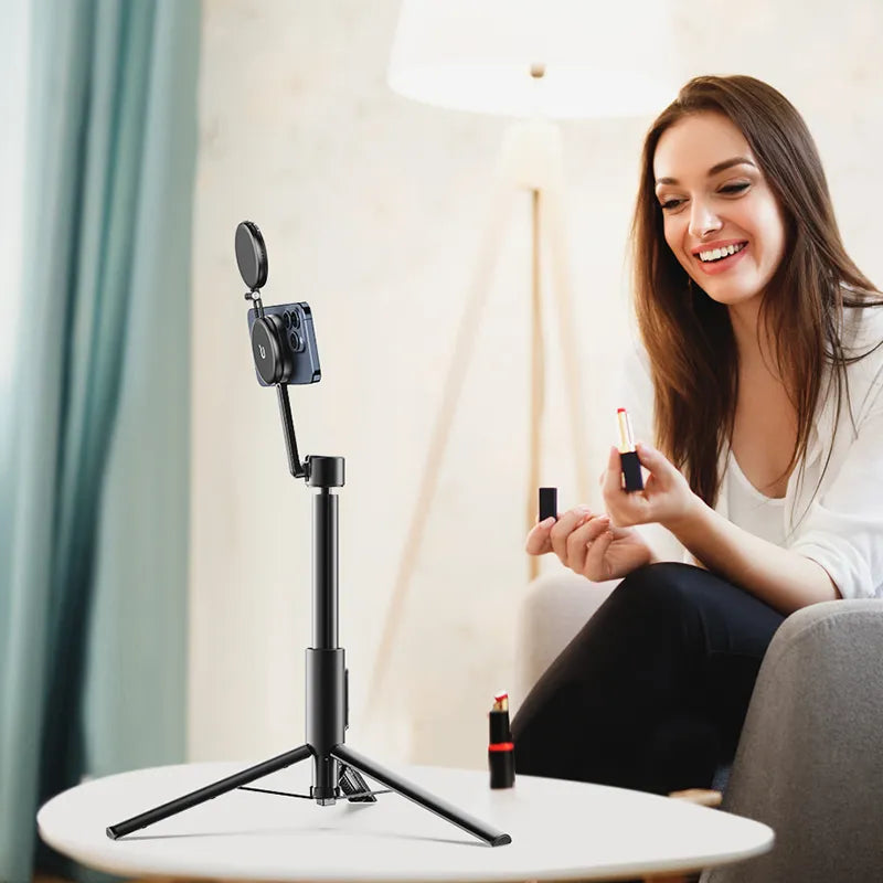 Woman applying lipstick using Ulanzi Magnetic Phone Selfie Stick Tripod indoors