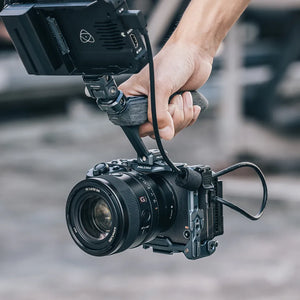 User holding Ulanzi Falcam F22 camera cage with Sony FX30 and handle