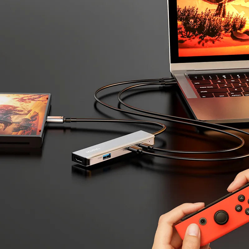 Compact USB-C video capture card connected to laptop and Nintendo Switch.