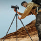 Photographer using TreeRoot Quick Lock Lite Tripod in a desert landscape.