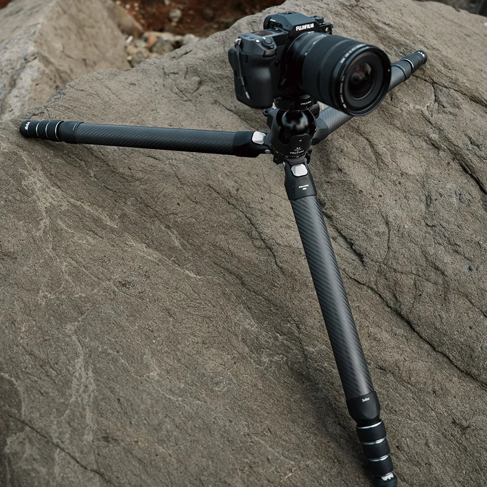 Ulanzi Falcam TreeRoot tripod with camera on rugged terrain.