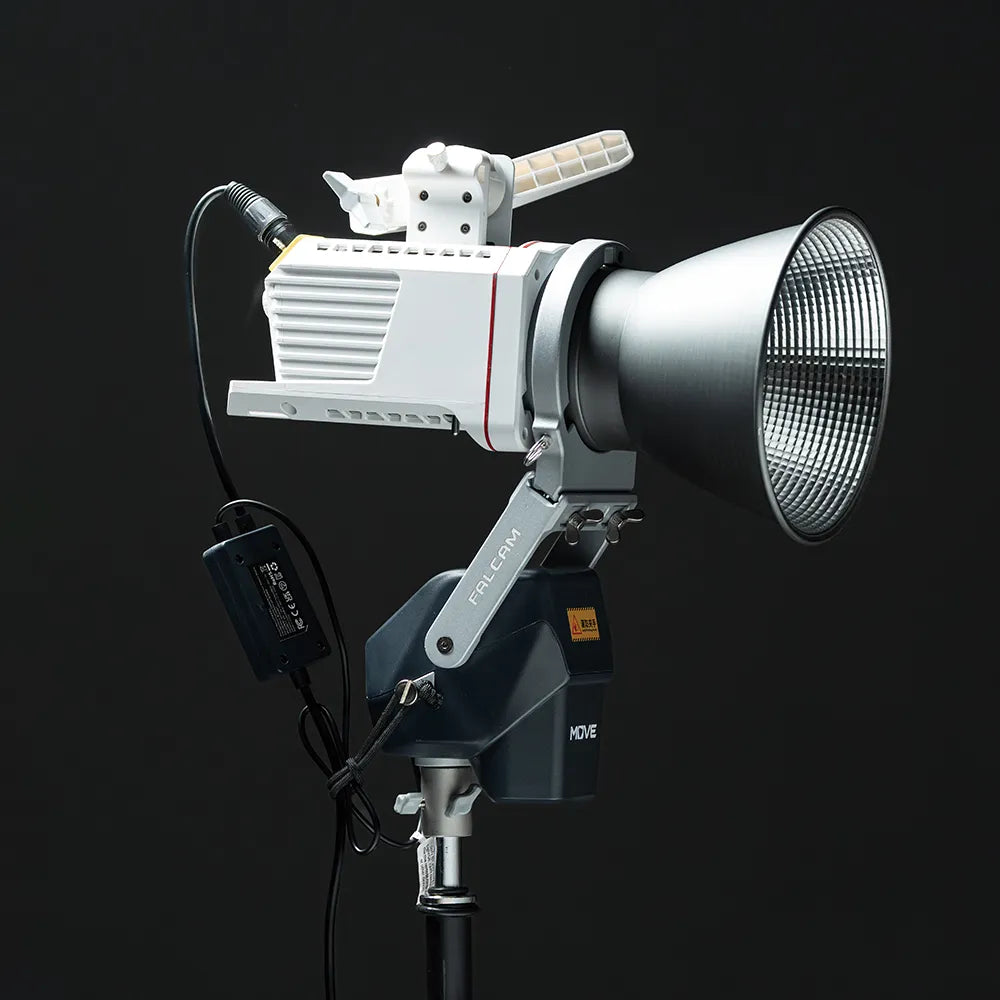 A professional FALCAM MOVE LED light setup with a reflector and power adapter for remote-controlled lighting.