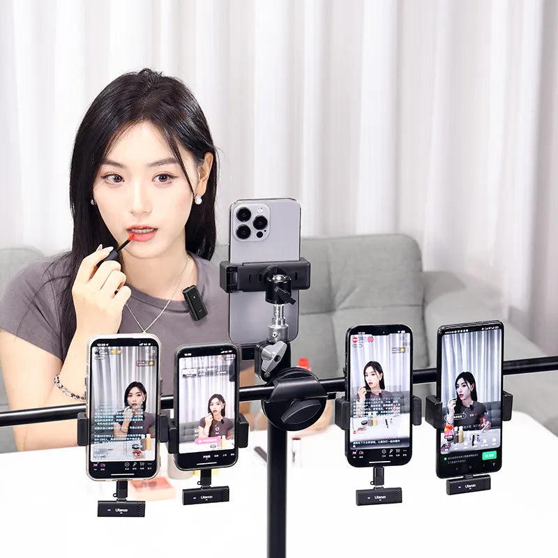 Woman applying lipstick while recording with multiple smartphones on a rig