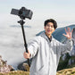 TT53 Traveler-Uka Tripod used as a handheld monopod for vlogging in a scenic mountain setting.