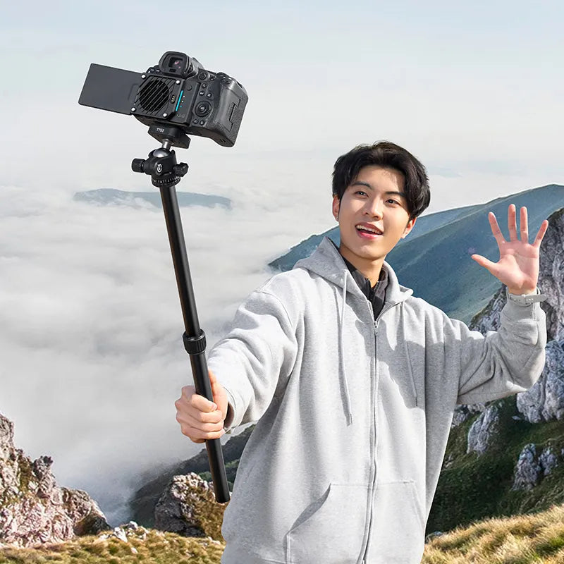 TT53 Traveler-Uka Tripod used as a handheld monopod for vlogging in a scenic mountain setting.