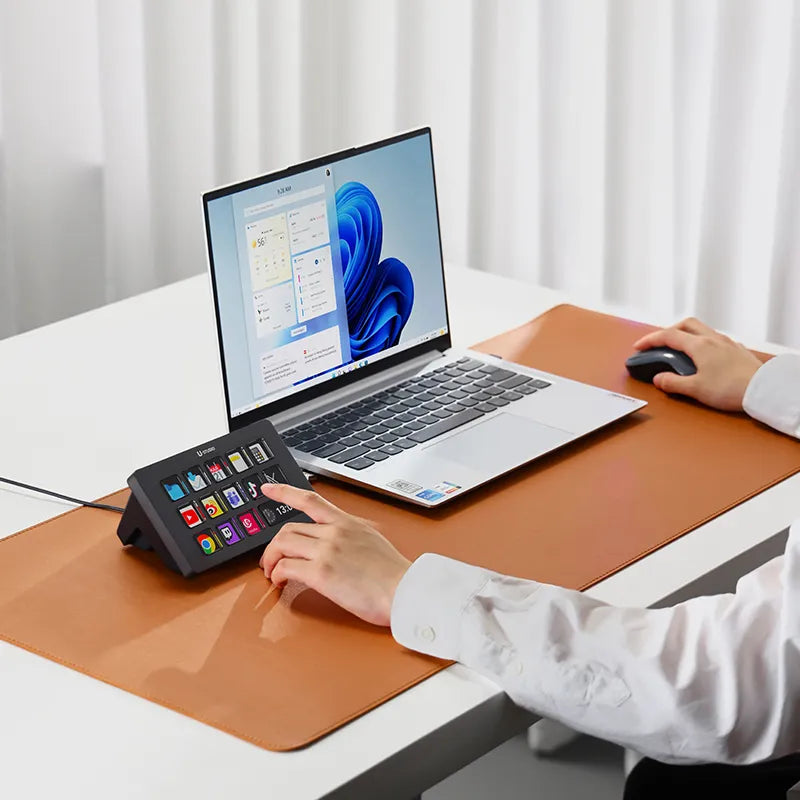 User operating Ulanzi Stream Controller D200 with laptop on desk.