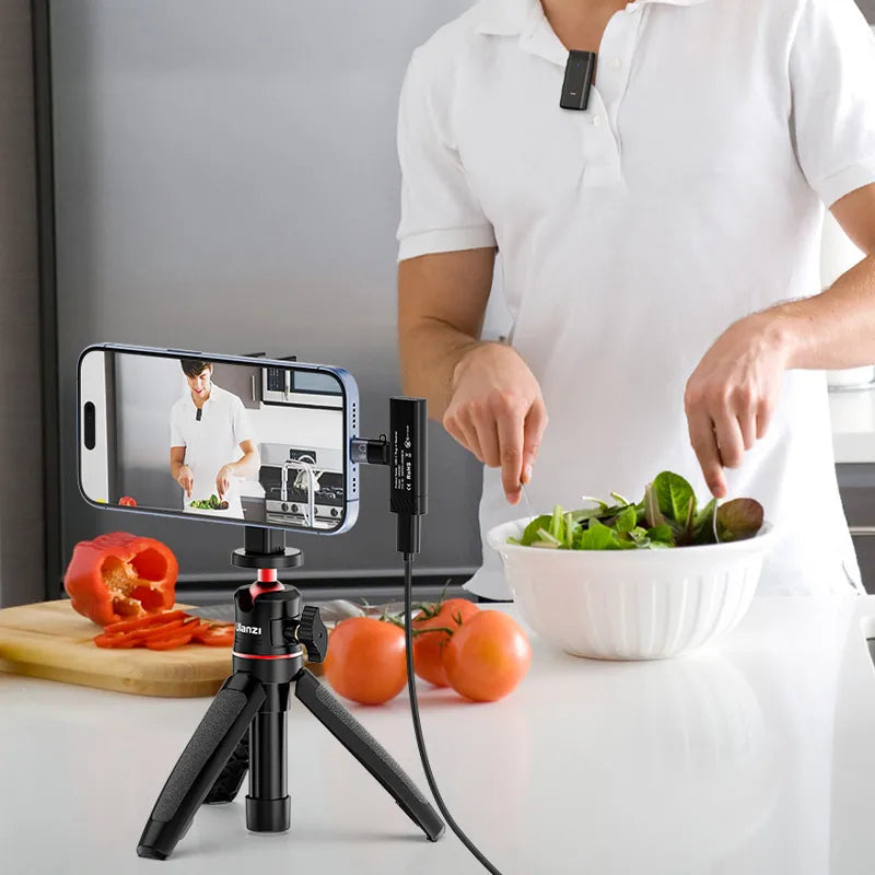 Man cooking with Ulanzi HM2301 microphone, smartphone on tripod, and fresh vegetables.