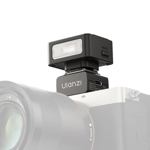 Ulanzi LA10 mini flash trigger mounted on a camera, showing the 'MODE' button.