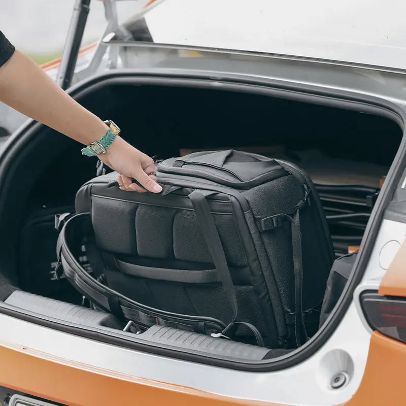 Ulanzi BP10 camera backpack being stored in car trunk for travel.