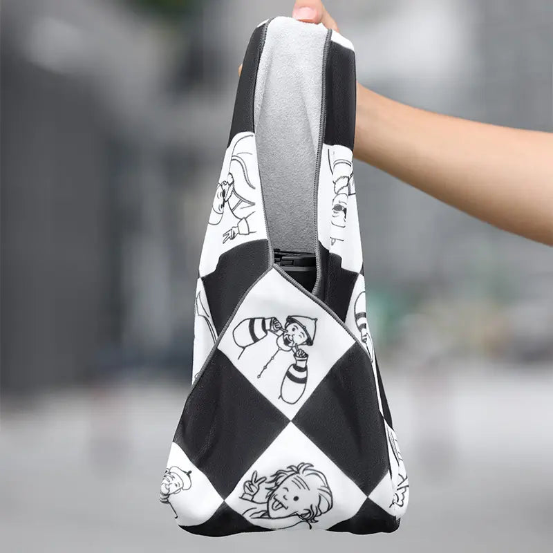 Ulanzi 17.7-inch protective wrap with black and white cartoon design held by a hand