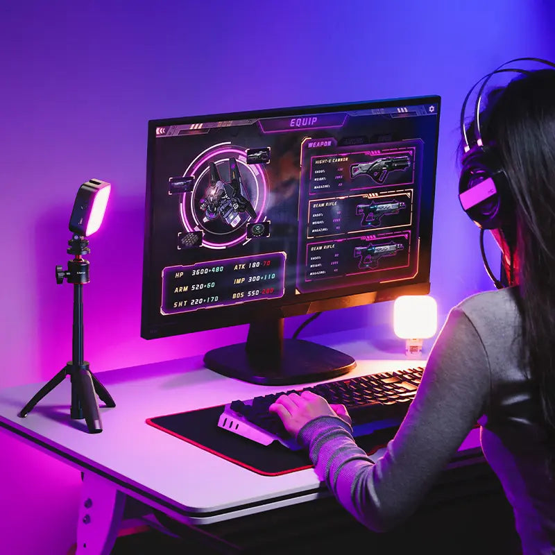 Ulanzi U60 RGB video light on a desk illuminating a gaming setup with a monitor.