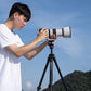 User adjusting camera on Ulanzi Ombra YING tripod in outdoor setting