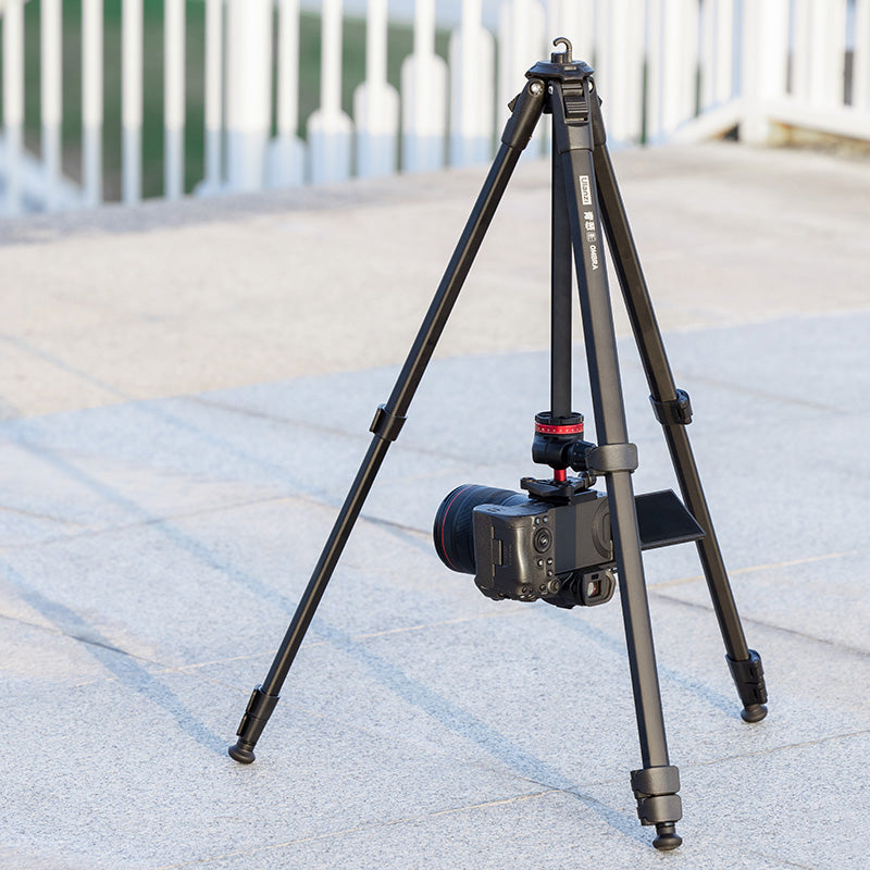Ulanzi Ombra YING Travel Tripod with camera, set up outdoors on a solid surface.