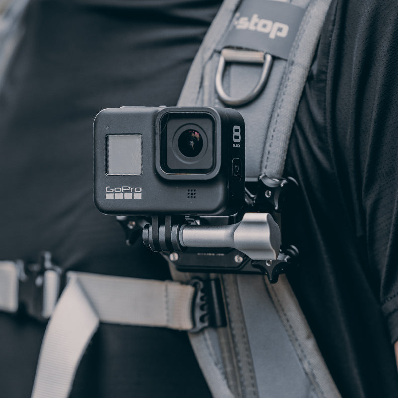 GoPro action camera attached to F22 quick release mount on a backpack strap.