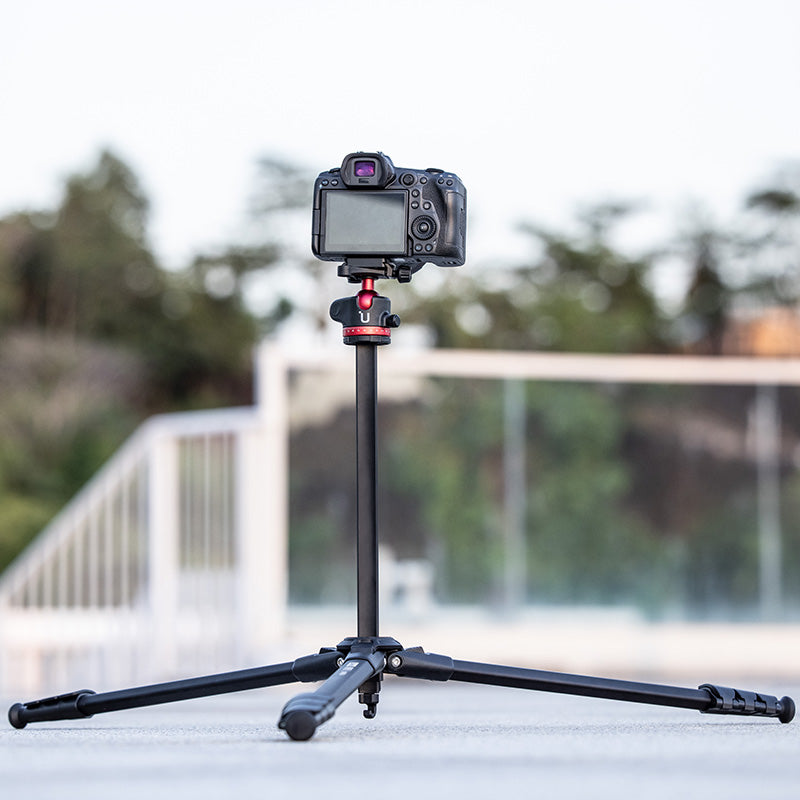 Ulanzi Ombra YING Travel Tripod set up with camera outdoors, showcasing stable design.