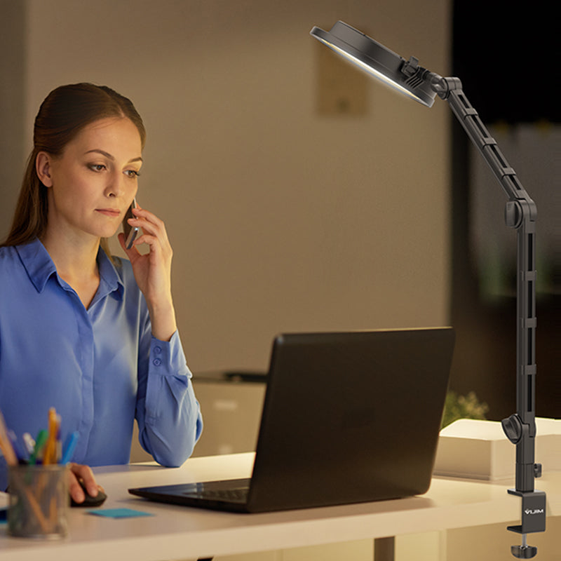 Woman using Ulanzi LS25 desk setup stand with LED light while on a phone call
