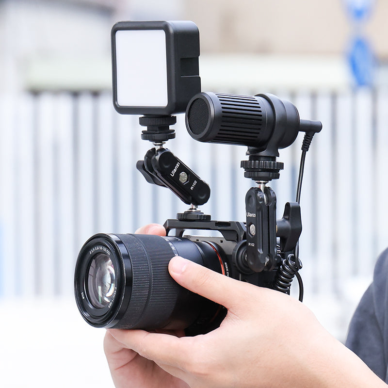 Camera setup with Ulanzi LED light and microphone attached for content creation.