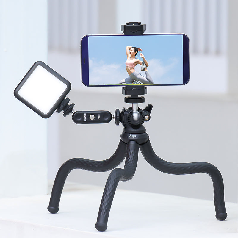 Smartphone on Ulanzi tripod with LED light for video recording.
