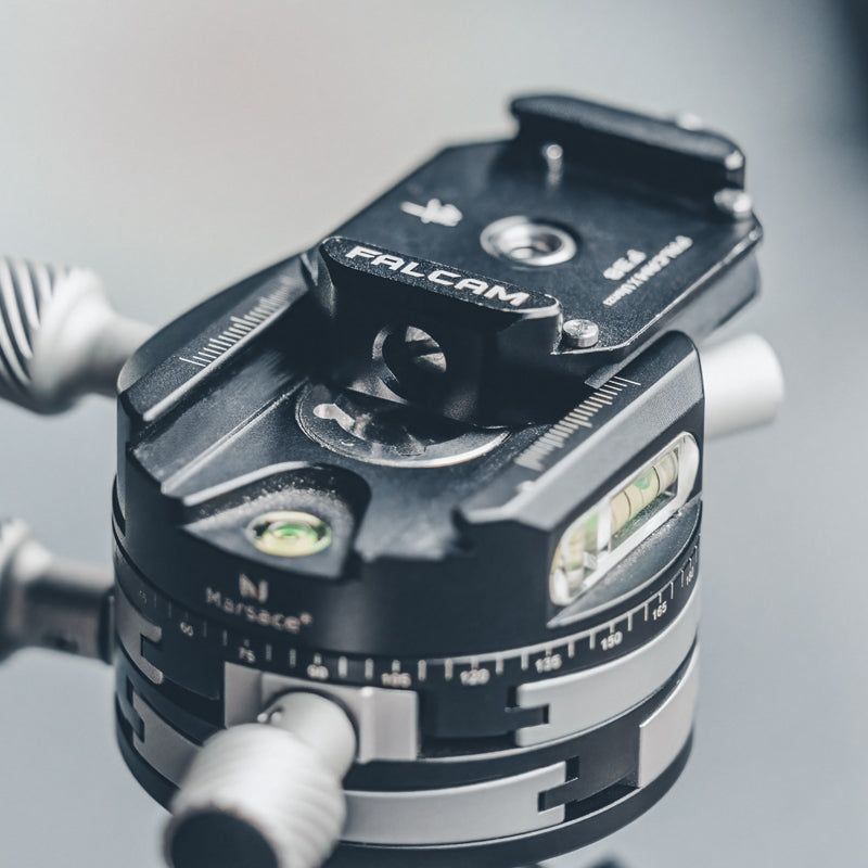Falcam F38 Quick Release Bottom Plate mounted with spirit level indicator on tripod.
