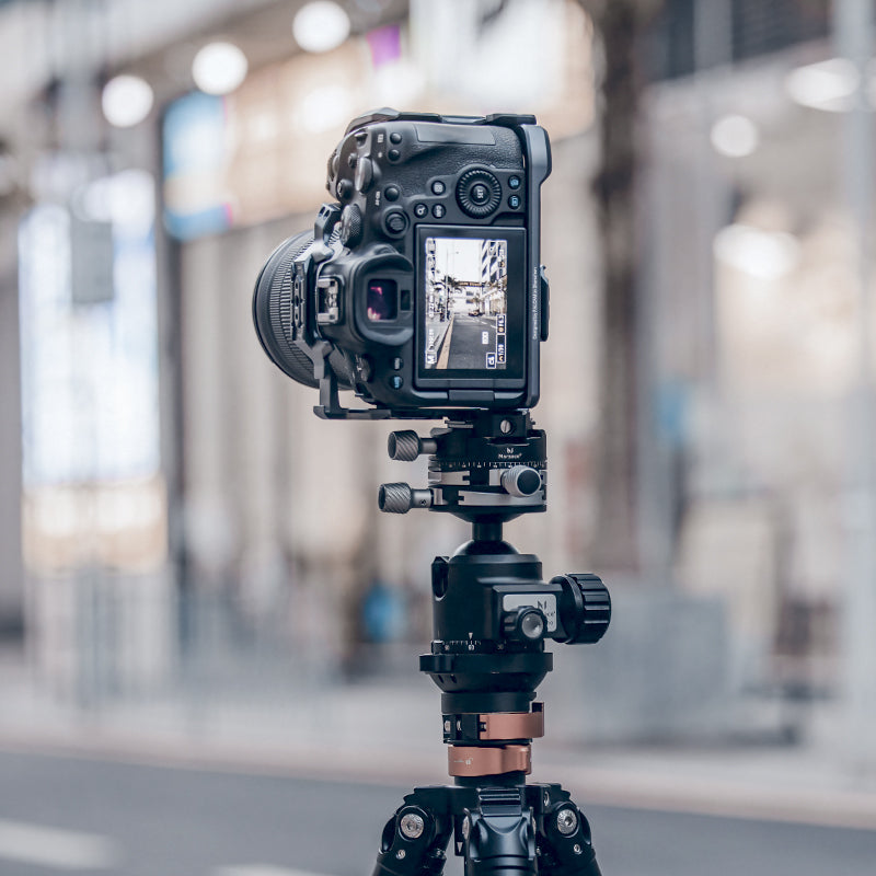 DSLR camera on tripod showcasing F38 Quick Release Bottom Plate for easy mounting.