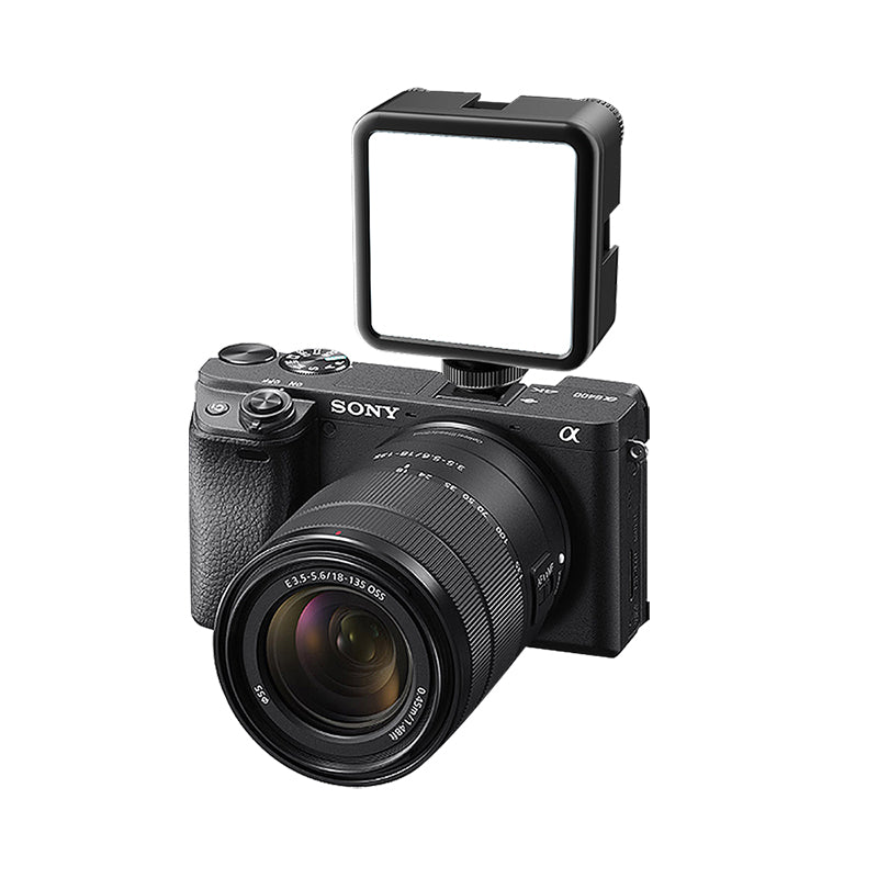Sony camera with mounted compact LED light for enhanced vlogging lighting.