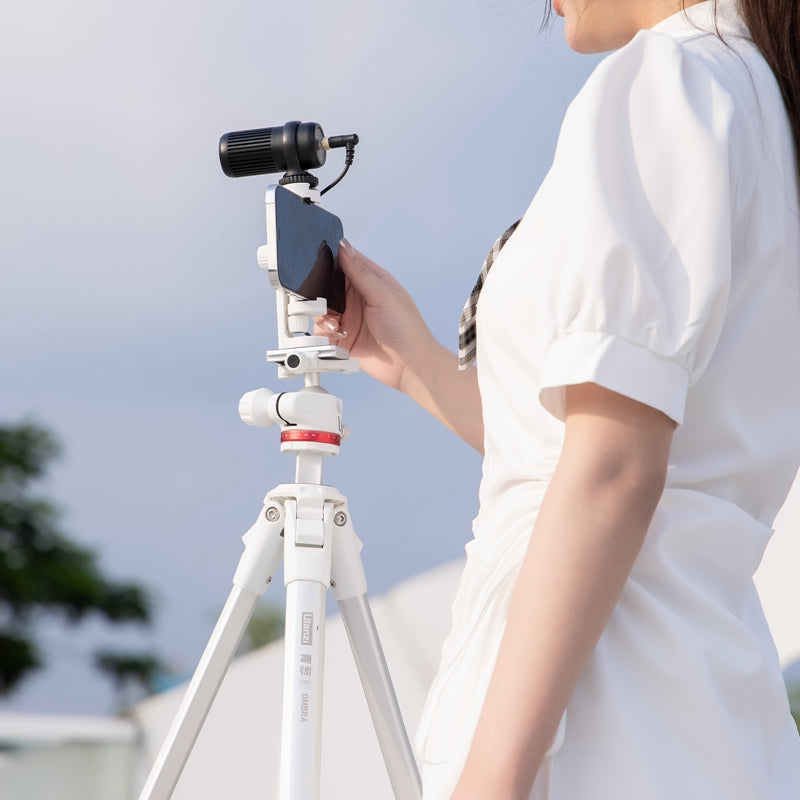 User adjusting smartphone on Ulanzi Ombra YING Travel Tripod outdoors