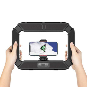 Ulanzi U200 ring light held, phone displaying skier, perfect for video recording.